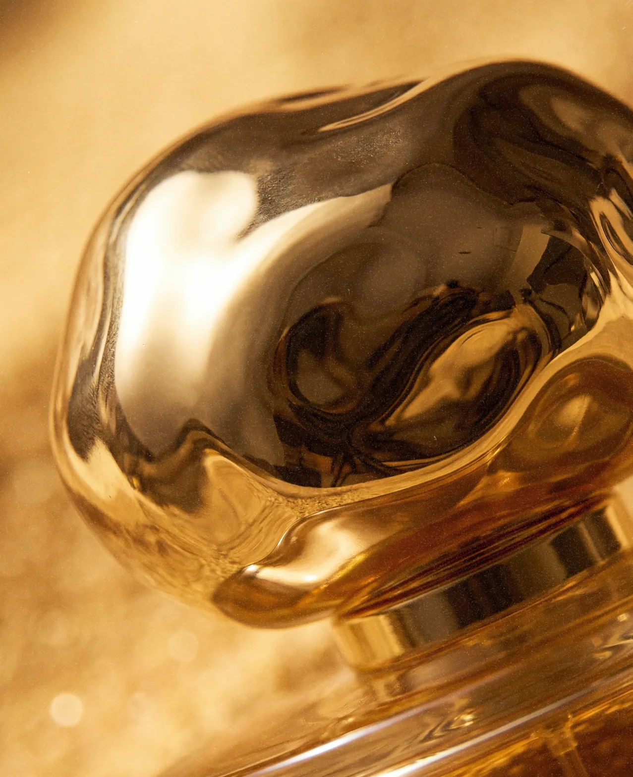 Celion — a macro of the bottle's sculptural gold cap