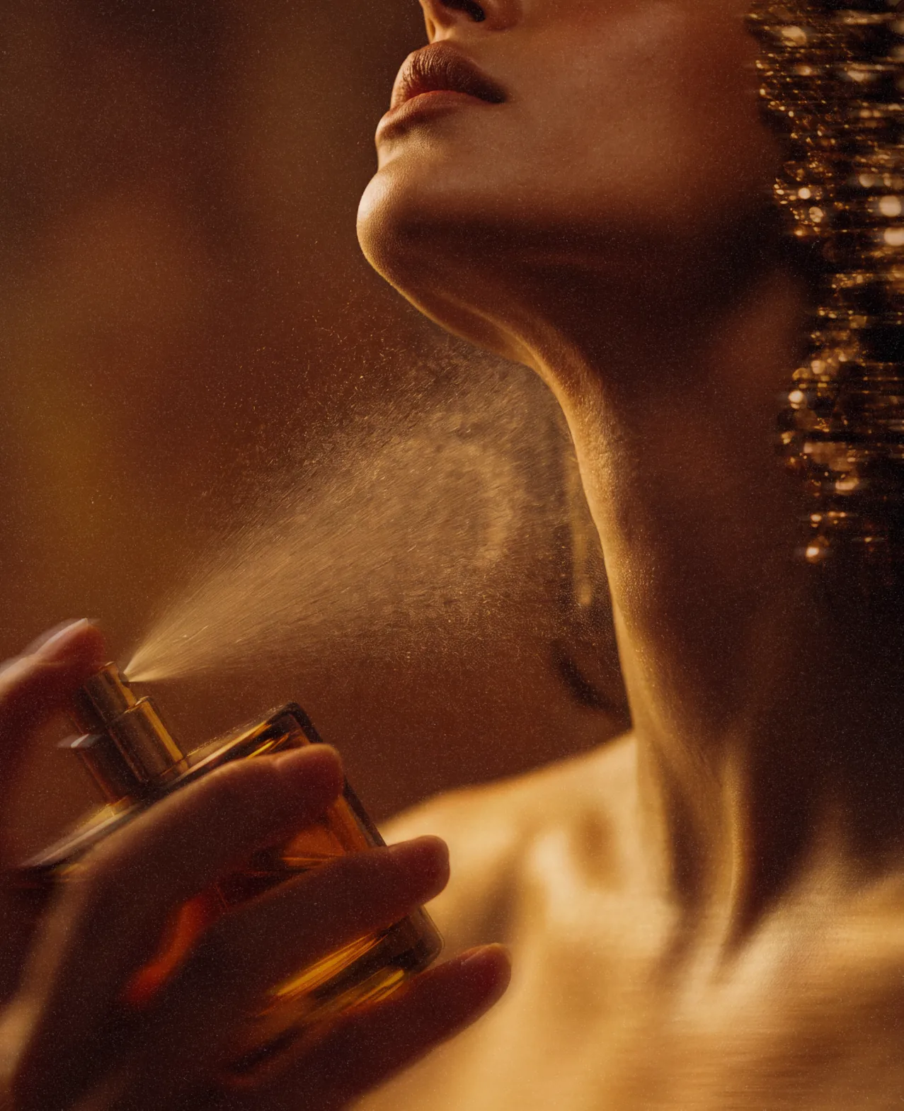 Celion — a model applying the fragrance, an editorial close-up in golden light