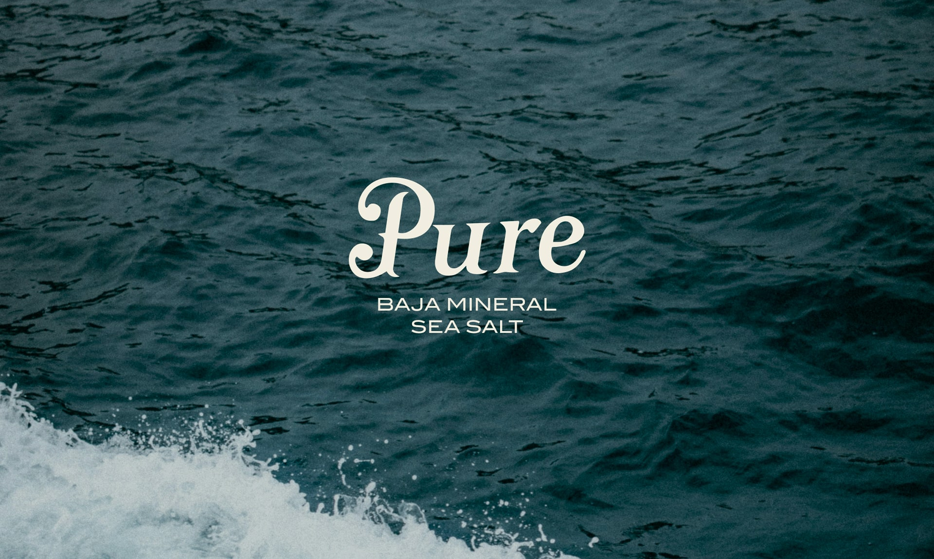 Pure — premium sea salt brand hero featuring the wordmark centered over the mineral-rich Baja California ocean
