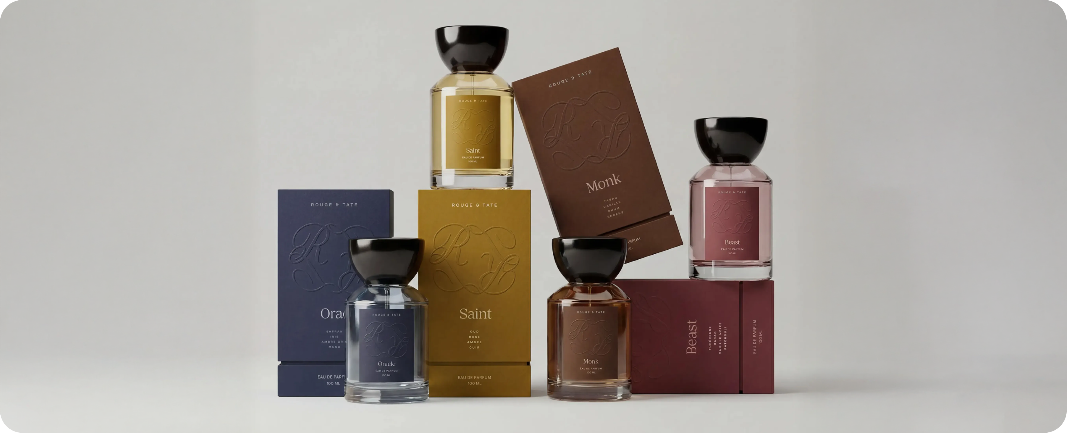 Rouge & Tate — the four archetypes staged together on a cream backdrop: Oracle, Saint, Monk, and Beast bottles paired with their embossed boxes