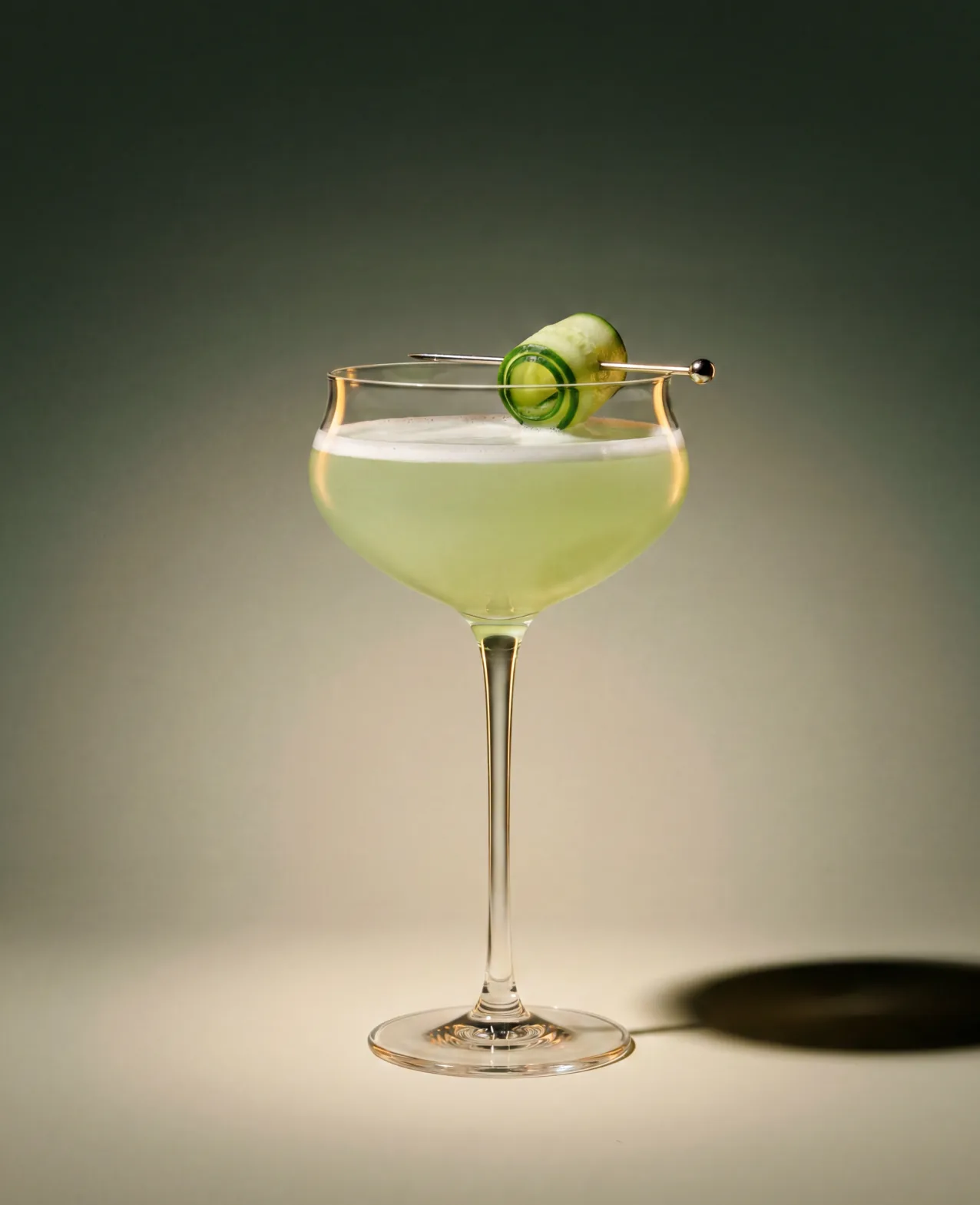 Verdadero — a coupe cocktail garnished with cucumber on a soft green backdrop