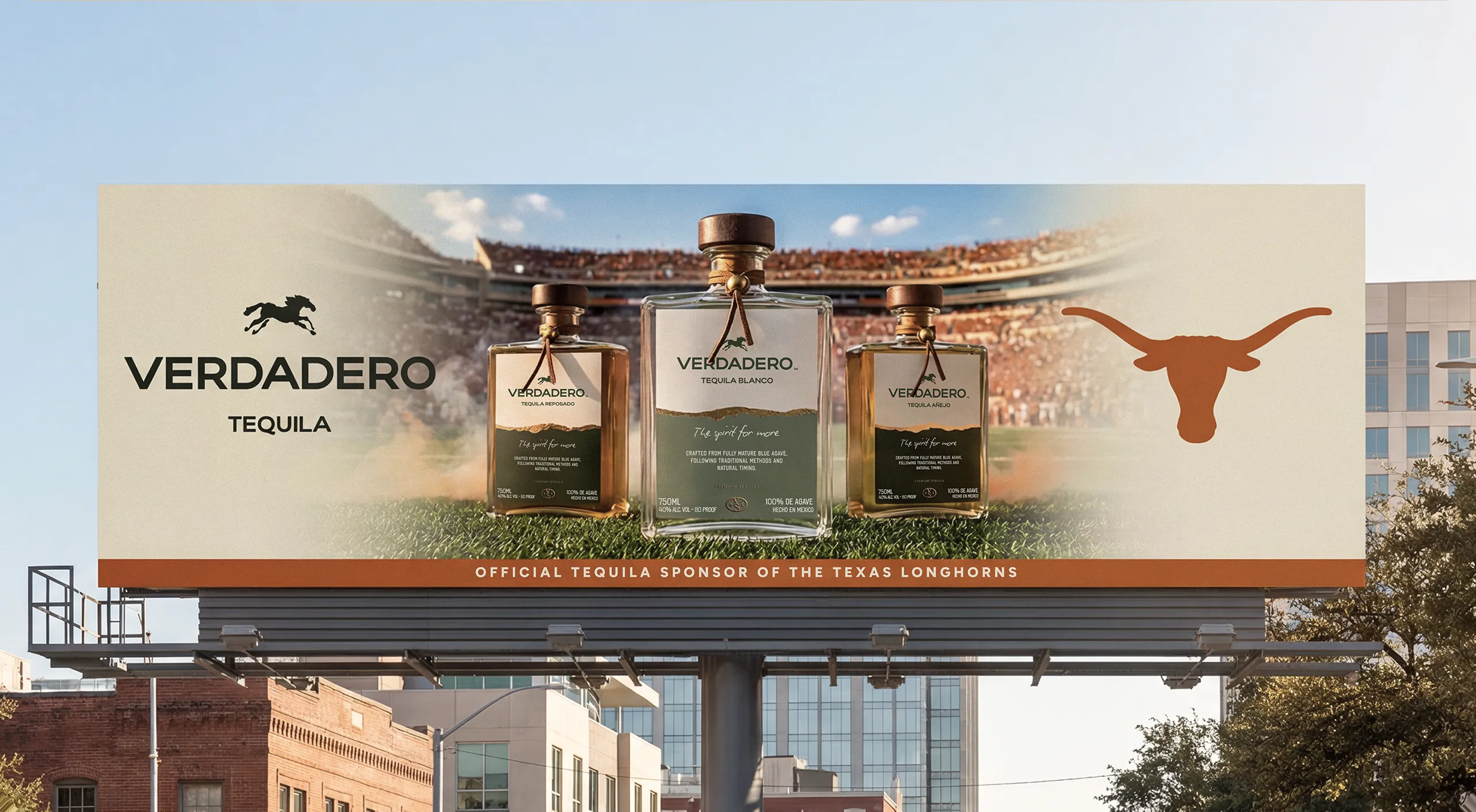 Verdadero — roadside billboard lining up three bottles with the Longhorn mark, reading 'Official Tequila Sponsor of the Texas Longhorns'