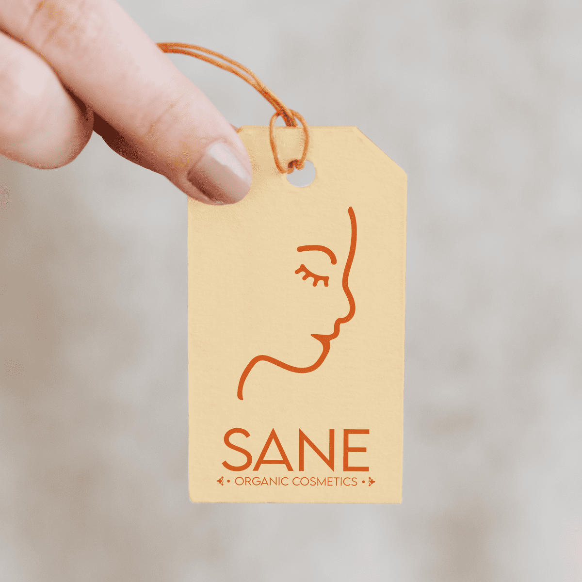 Yellow pastel tag of organic cosmetics, with brand logo and name in orange
