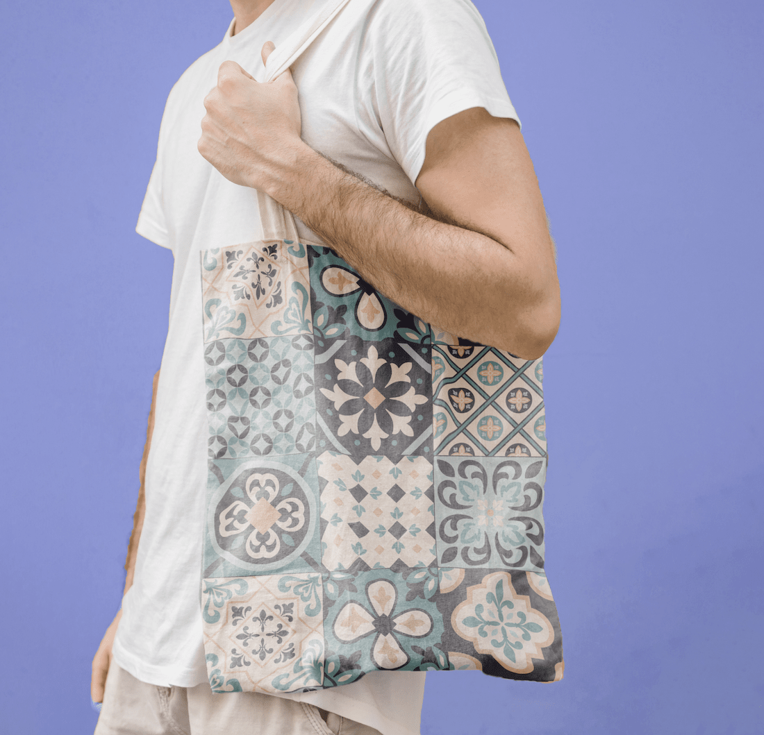 man holding tote bag with mandala design
