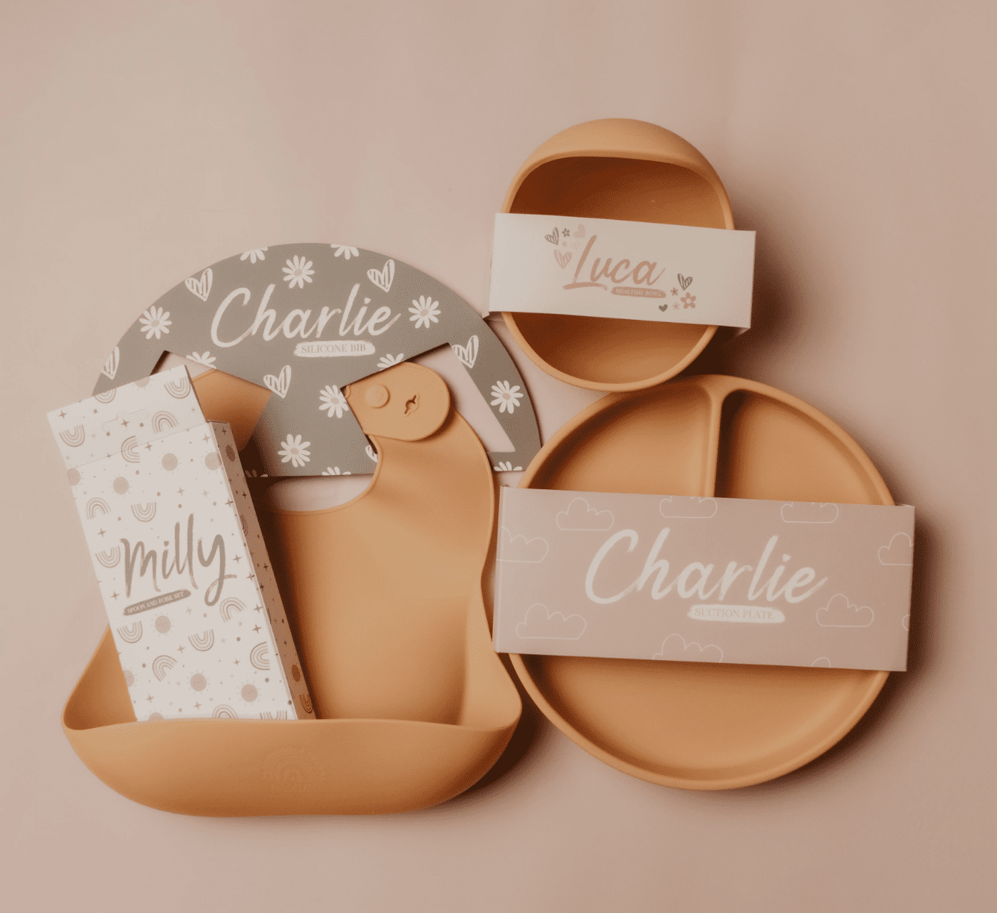 three brown pieces of baby silicone plates. With cute packaging in pastel colors