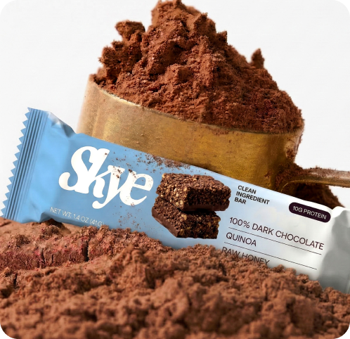 Skye dark chocolate quinoa bar packaging on cocoa powder, AI Photo Studio output by CreativeWise